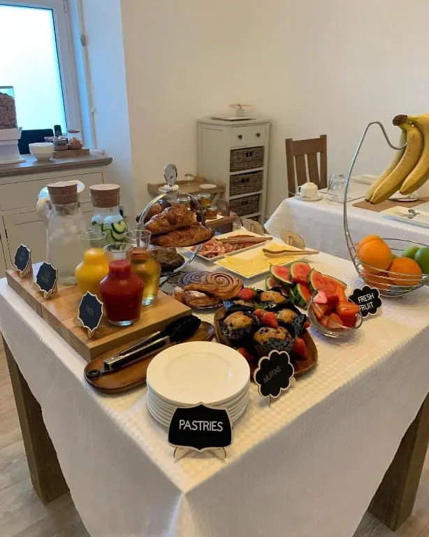 a table with a buffet of breakfast foods on it at Clune House B&B in Newtonmore