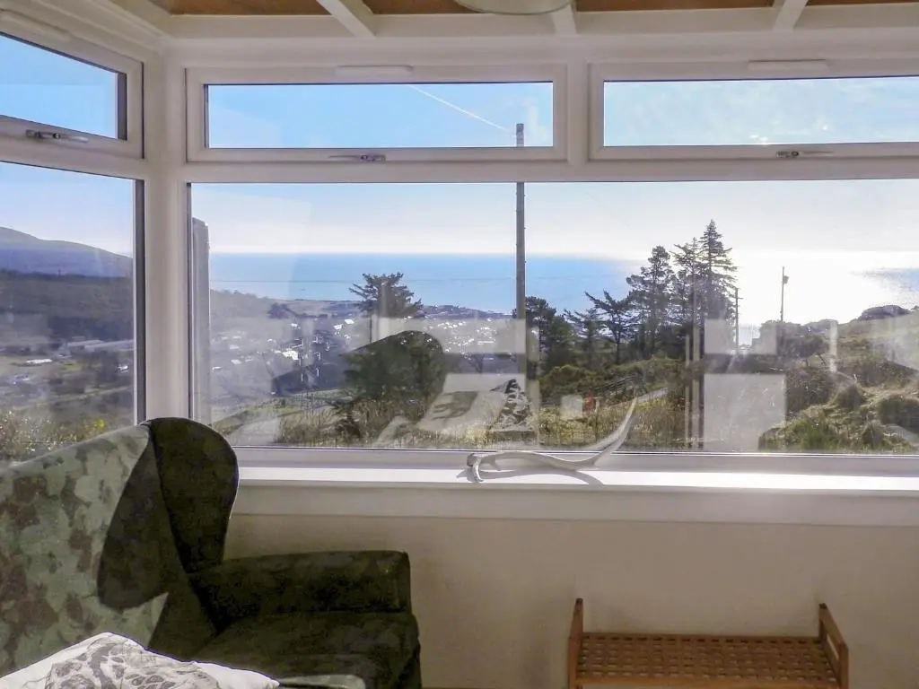 a window with a chair in a room with a view at Farr in Helmsdale