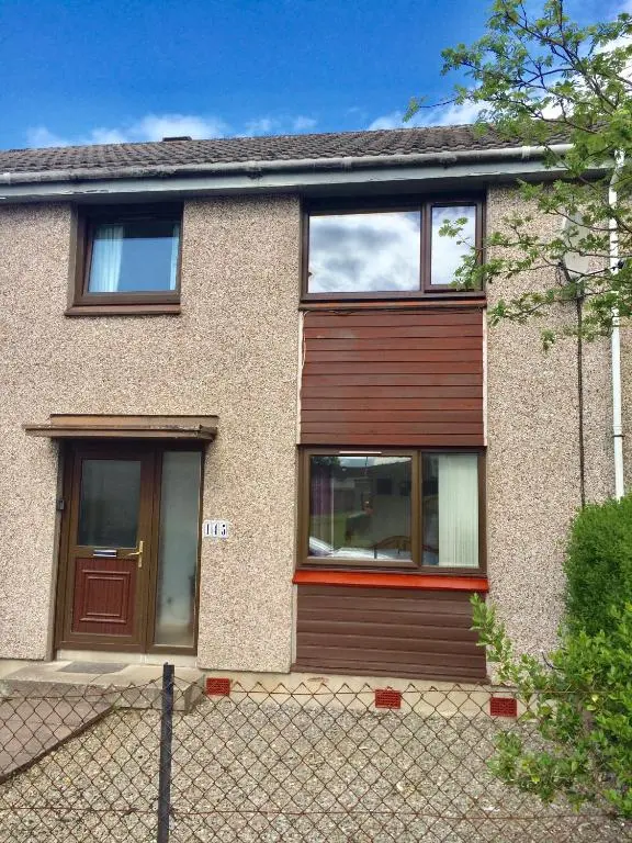 a house with a wooden door and windows at Inverken House in Inverness