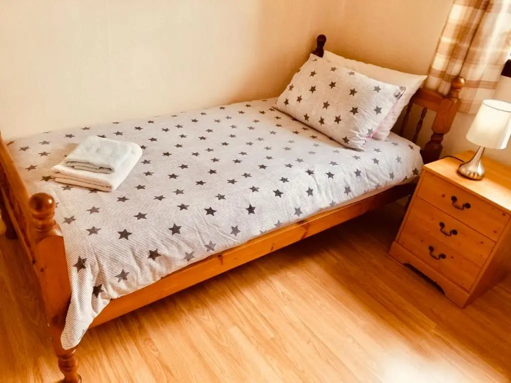 a small bed in a room with a night stand at Inverken House in Inverness