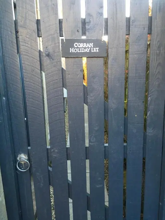 a fence with a sign that reads corazon holiday lift at Corran Cottage in Inverness
