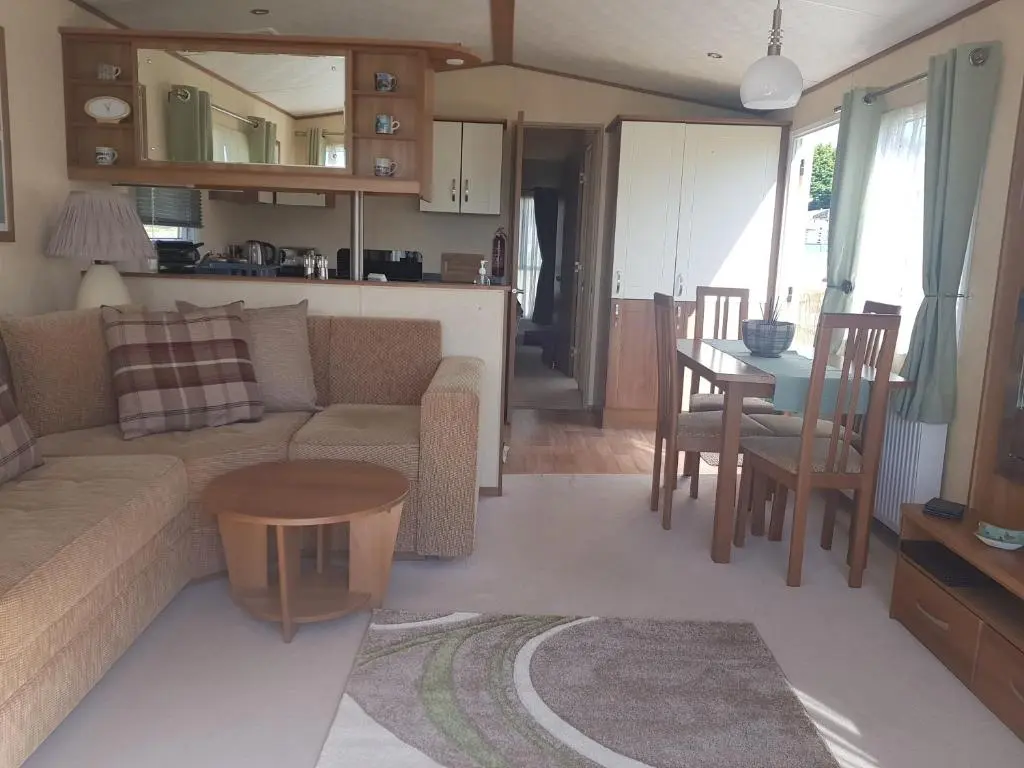 a living room with a couch and a table at No42 Wild Goose in Dornoch