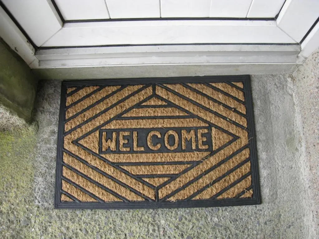 a welcome sign on the side of a building at Greenfield Cottage in Thrumster