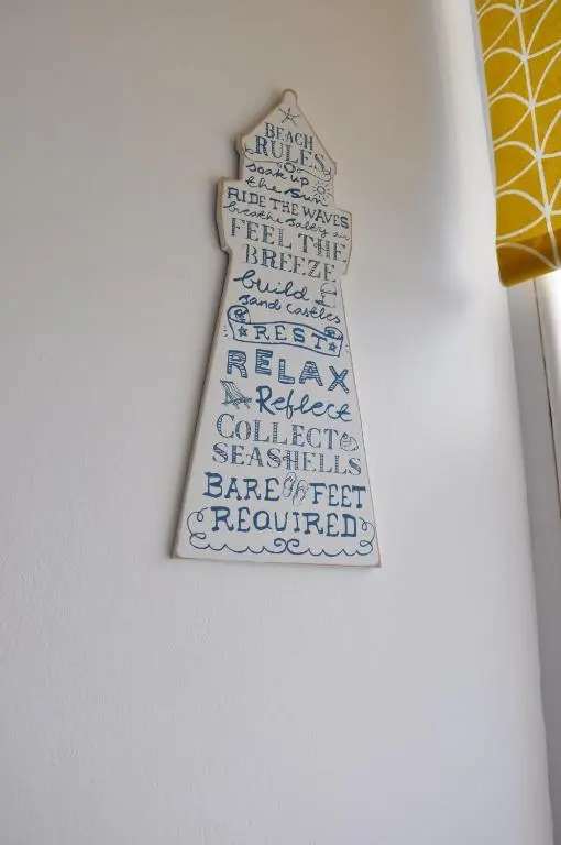 a wooden christmas tree ornament hanging on a wall at Emahroo Cullen in Cullen