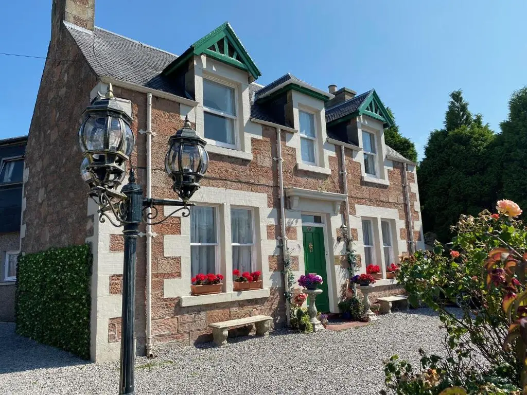 a house with a street light in front of it at Bosta B&B in Inverness