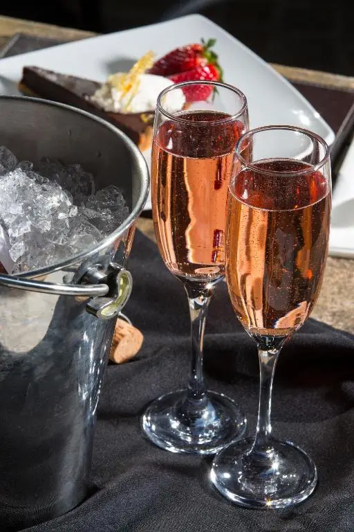 two glasses of champagne sitting on a table at Redcliffe Hotel in Inverness