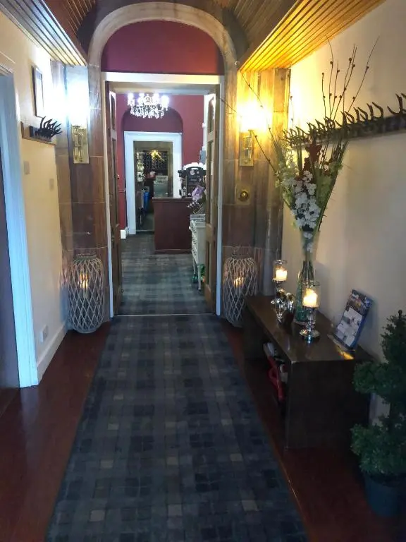 a hallway of a building with a hallwayngth at Redcliffe Hotel in Inverness