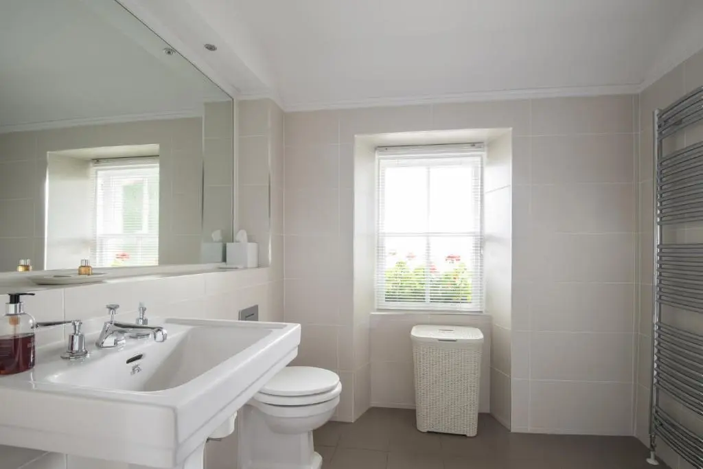 a white bathroom with a sink and a toilet at The Redgarth in Oldmeldrum