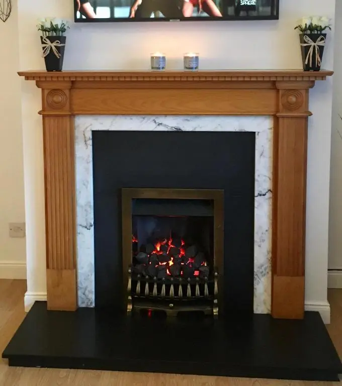 a fireplace with a fire in it at Wellingtonia Court Apartment in Inverness
