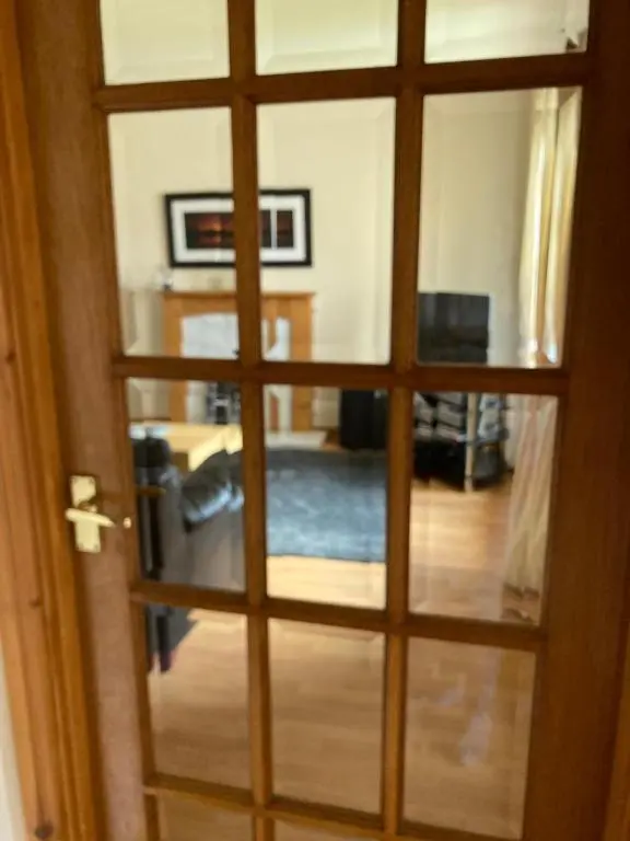 a view of a living room through a glass door at Sunbury Aviemore in Aviemore