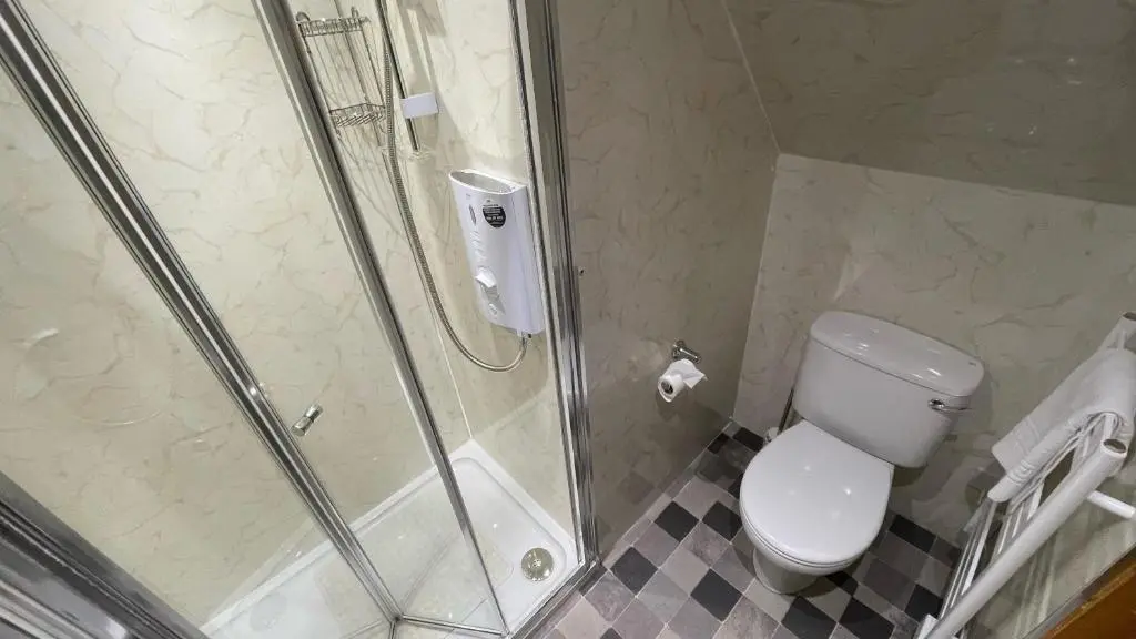 a bathroom with a shower and a toilet and a sink at Kerrowdown Cottage-Self Catering for 4 in the Highlands in Drumnadrochit