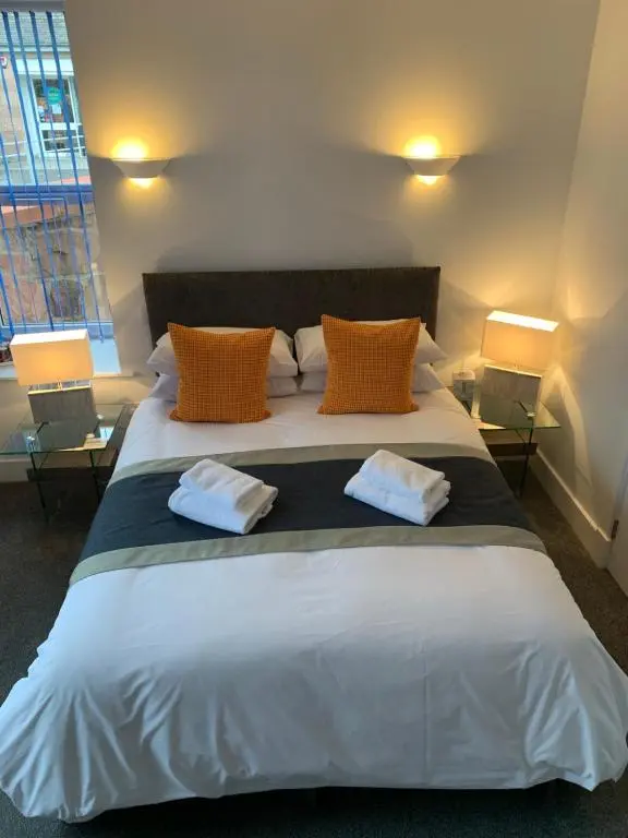 a bedroom with a large bed with two towels on it at Muir Bank in Muir of Ord