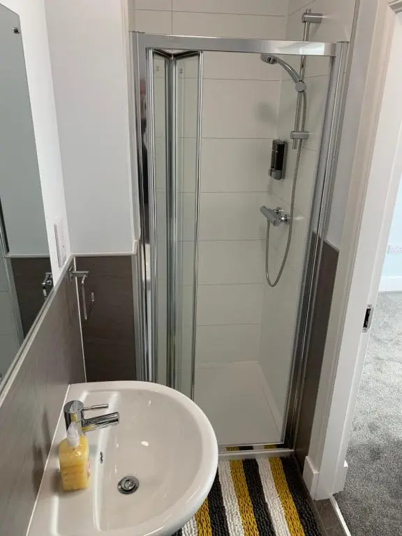 a bathroom with a sink and a shower at Muir Bank in Muir of Ord