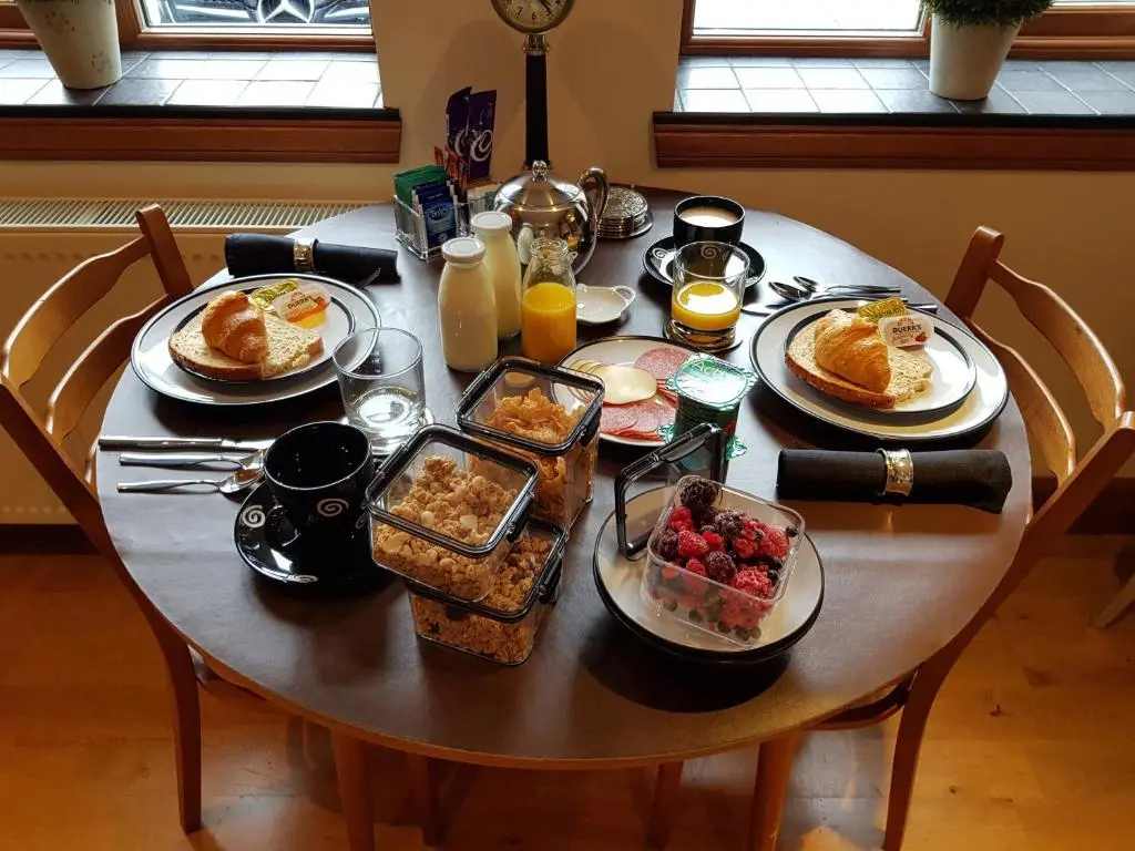 a table with plates of breakfast food on it at The Smiddy Suite in Ellon