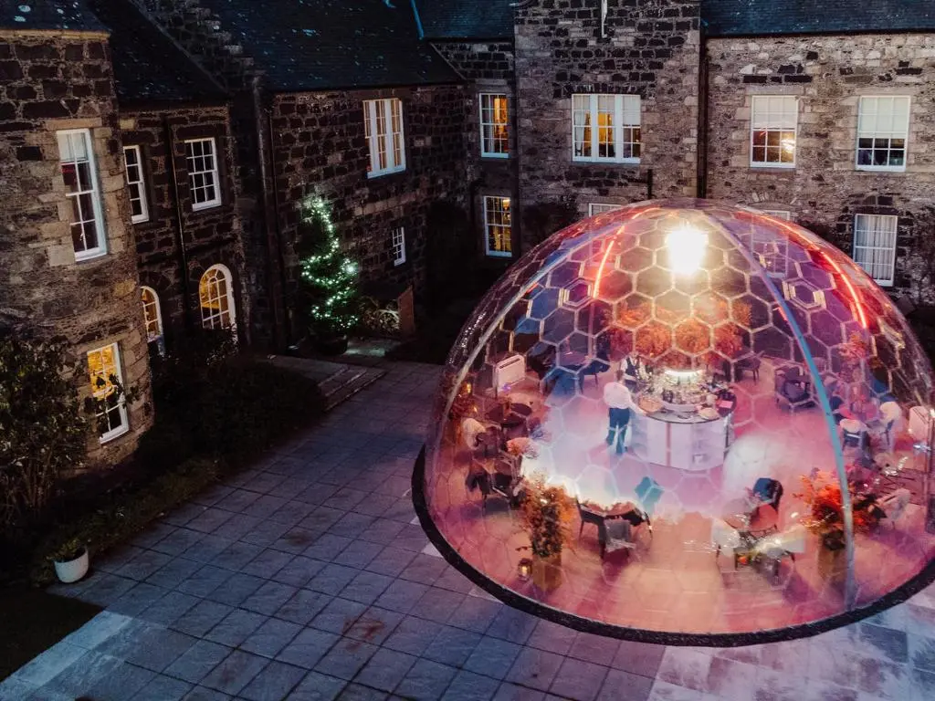 an image of a wedding in a honeycomb ball at night at Meldrum House Hotel Golf And Country Estate in Oldmeldrum