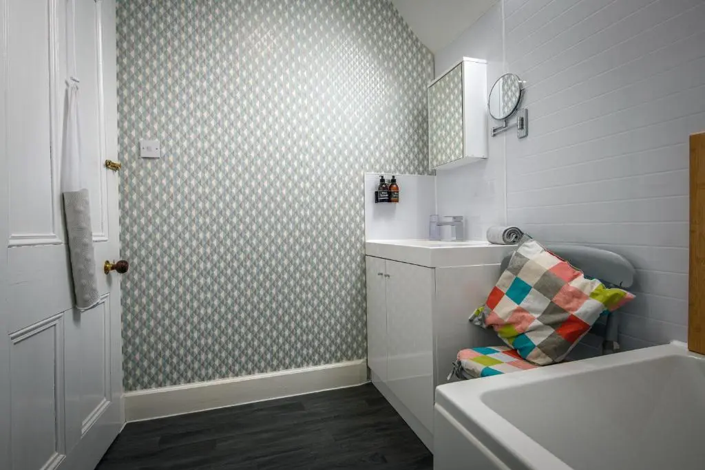 a bathroom with a sink and a toilet and a tub at Charming Townhouse on North Coast 500 Route, Wick in Wick