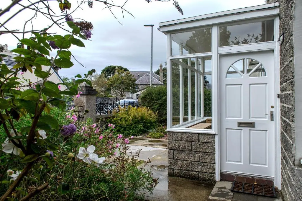 a white door on a house with a garden at Charming Townhouse on North Coast 500 Route, Wick in Wick