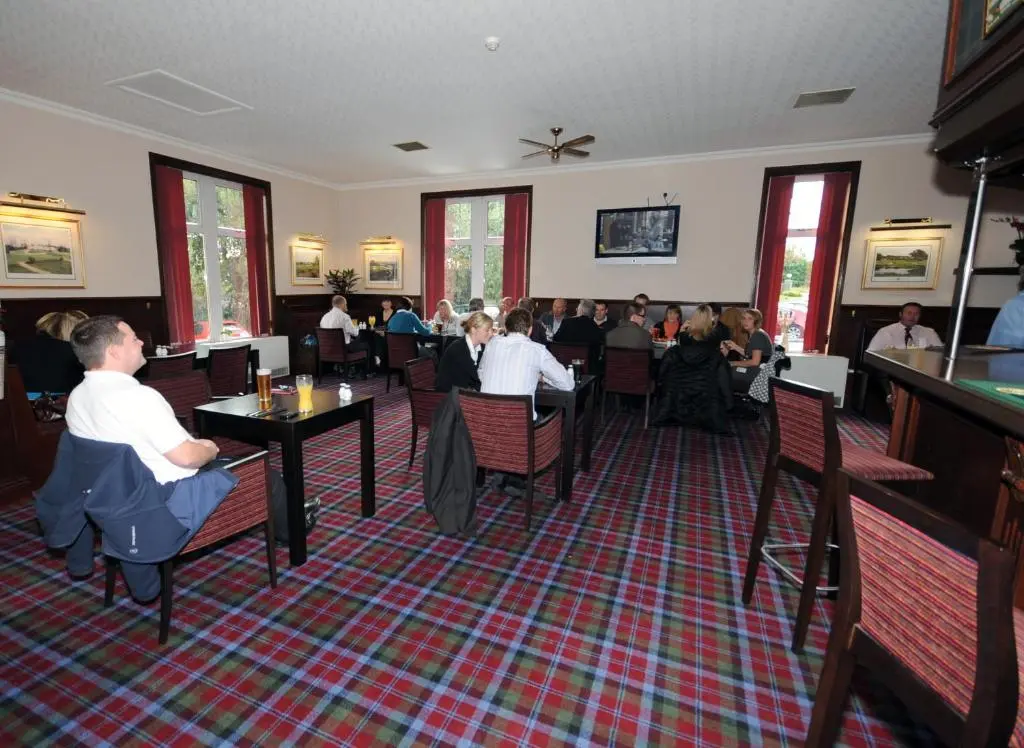 a group of people sitting at tables in a restaurant at Pinehurst Lodge Hotel -Dyce, Aberdeen in Dyce
