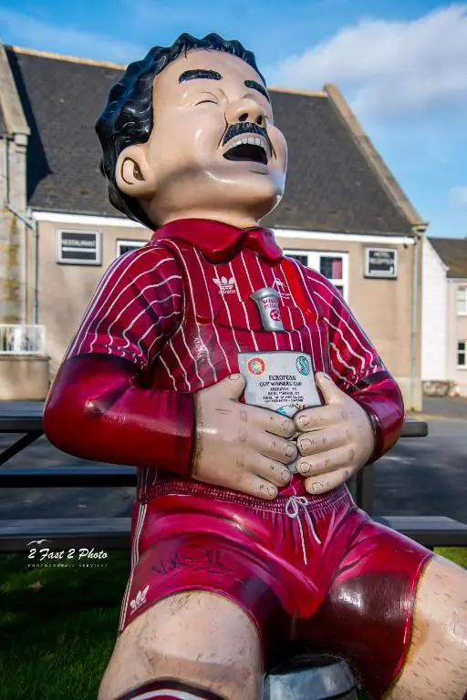 a statue of a man sitting on the grass at Pinehurst Lodge Hotel -Dyce, Aberdeen in Dyce