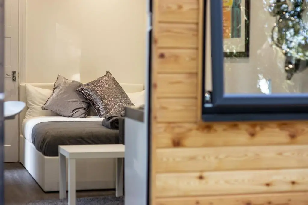 a bedroom with a couch with pillows on it at A UNIQUE Experience in a Converted Shipping Containers, Glamness is Adults Only in Inverness