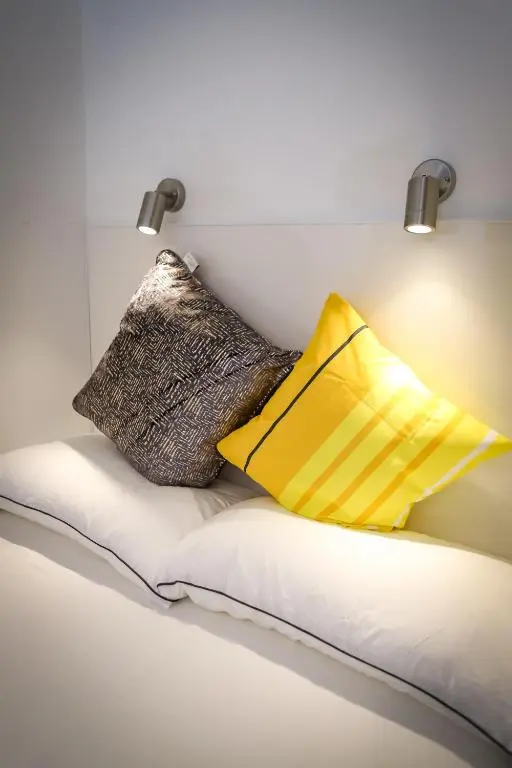 two pillows sitting on a couch in a room at A UNIQUE Experience in a Converted Shipping Containers, Glamness is Adults Only in Inverness