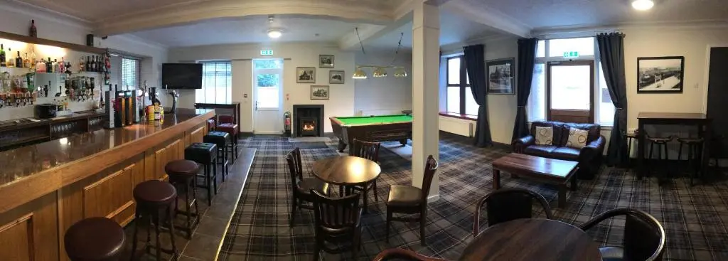 a bar in a pub with a pool table at Ord Arms Hotel in Muir of Ord