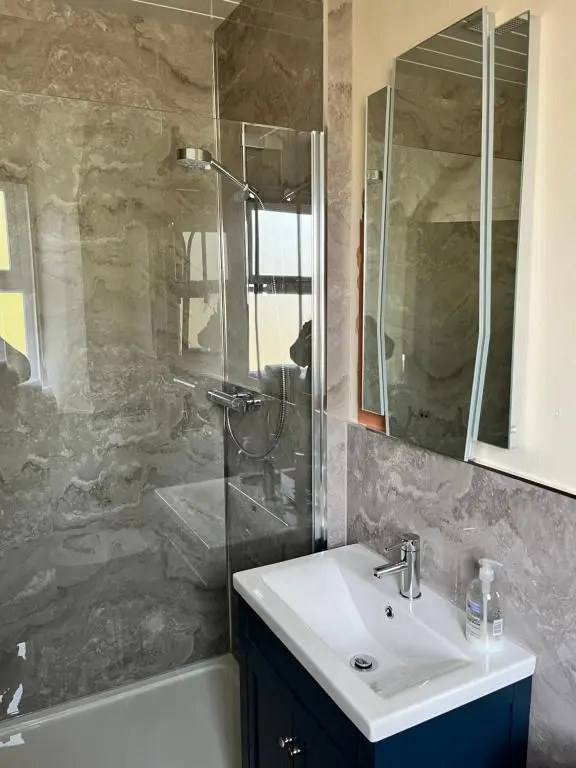 a bathroom with a sink and a shower at Ord Arms Hotel in Muir of Ord