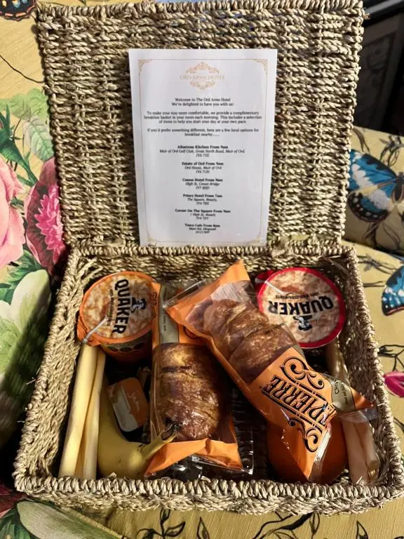 a basket filled with different types of food on a table at Ord Arms Hotel in Muir of Ord