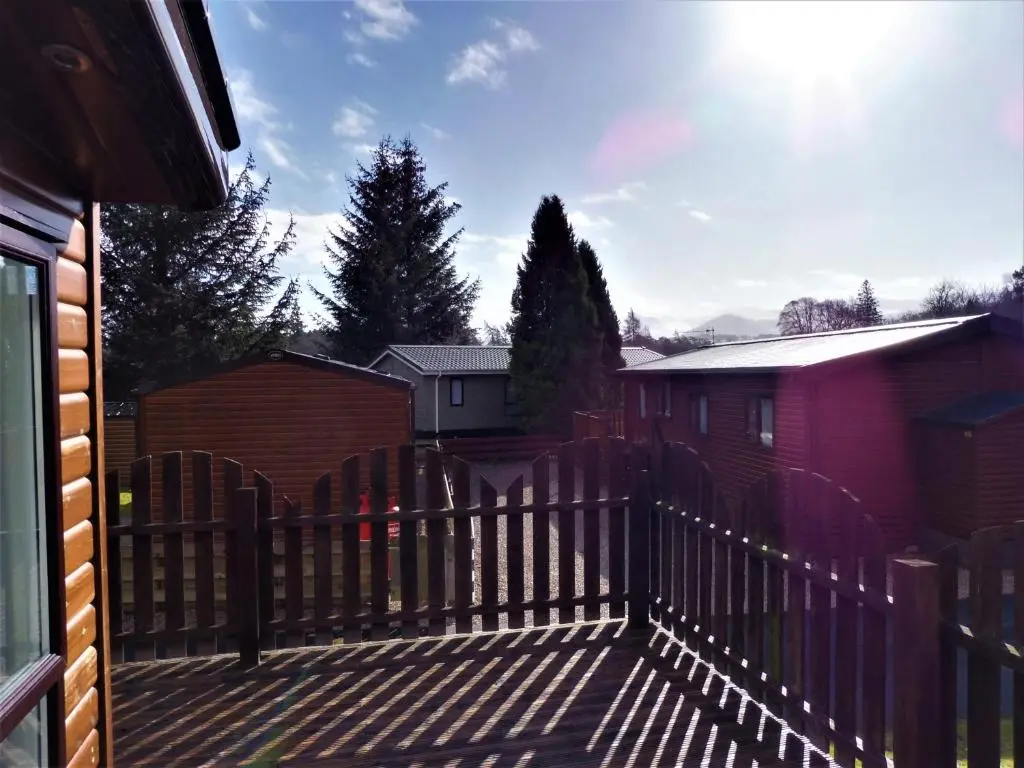 a wooden fence in front of a house at Ruapehu Lodge in Aviemore