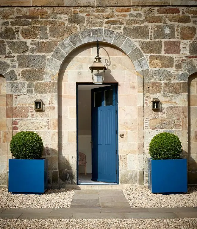 an entrance to a building with a blue door at Newhall Mains in Resolis