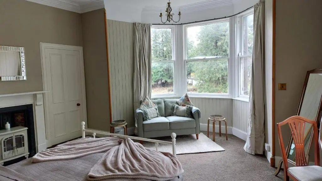 a living room with a chair and a window at Isla Bank House in Keith