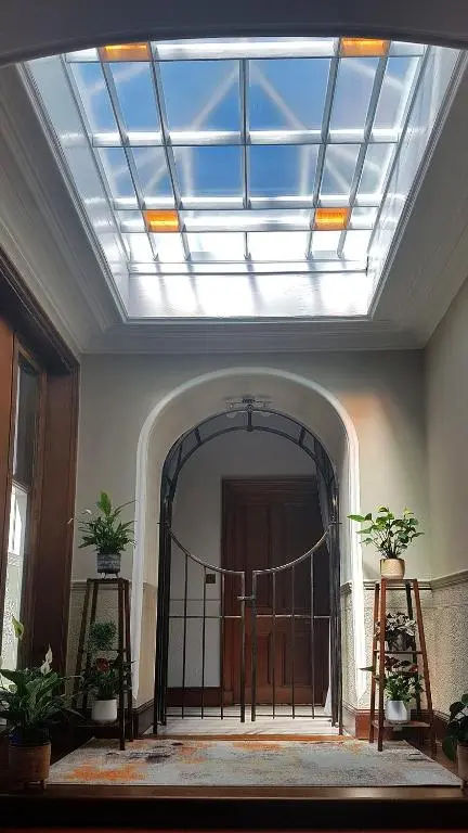 a skylight in a room with a door with plants at Isla Bank House in Keith