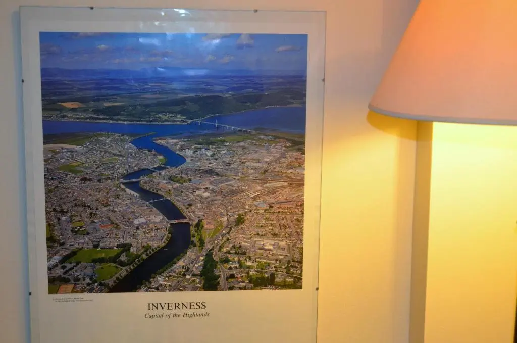 a picture hanging on a wall next to a lamp at The Quaich B&B in Inverness