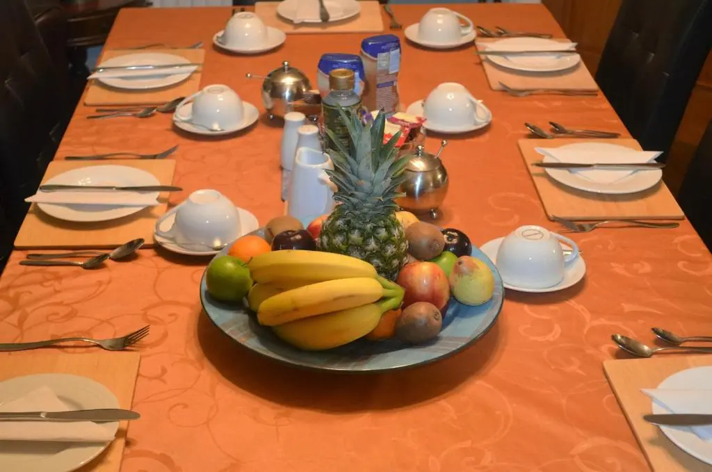 a table with a plate of fruit on it at The Quaich B&B in Inverness