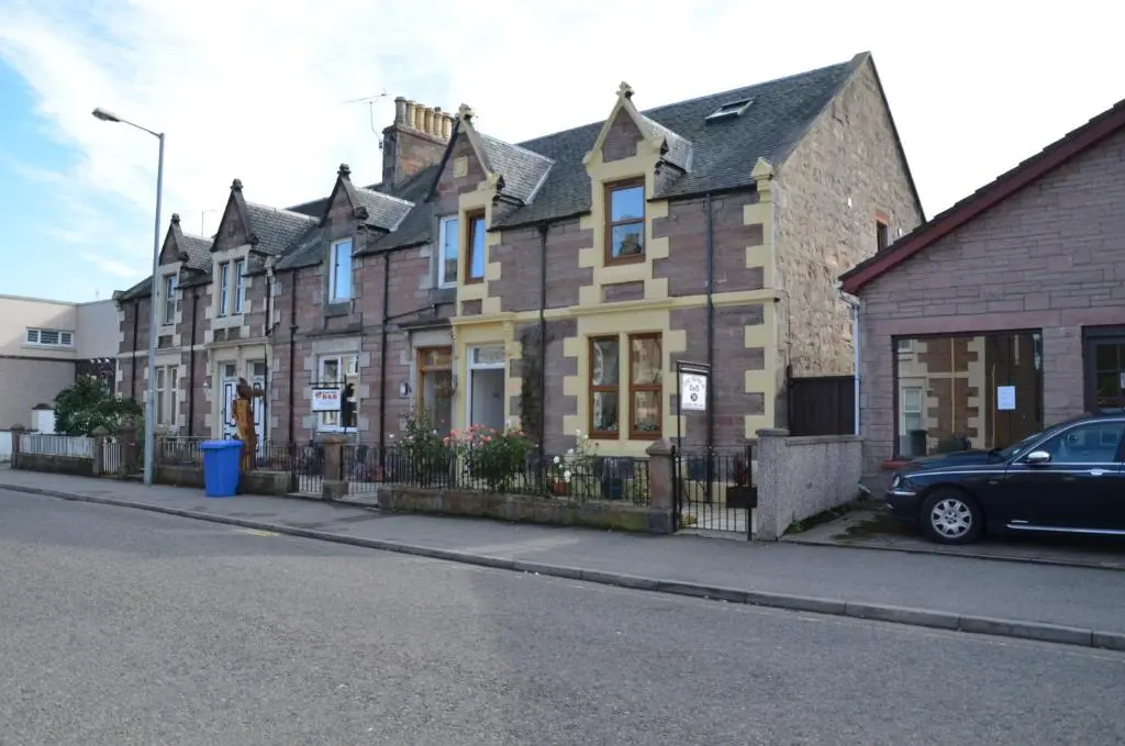 a building with a car parked in front of it at The Quaich B&B in Inverness