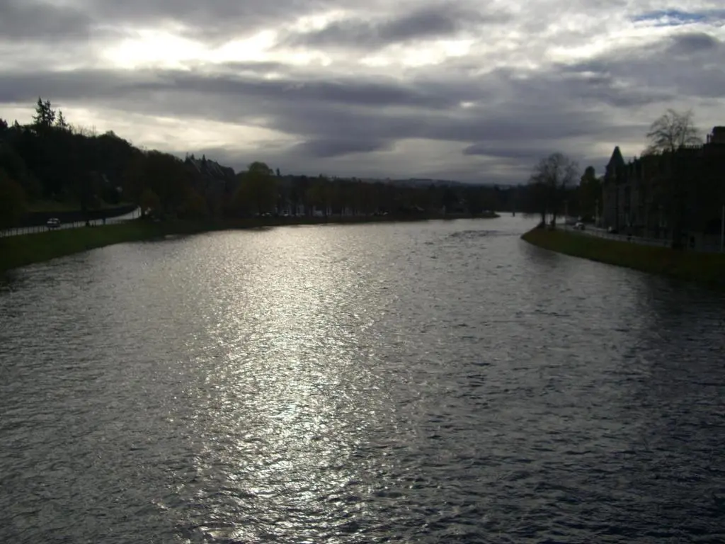a river with the sun reflecting on the water at The Quaich B&B in Inverness