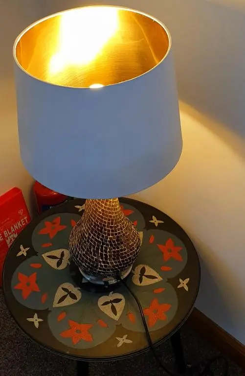 a lamp sitting on top of a table next to at Aldo's Place in Dingwall
