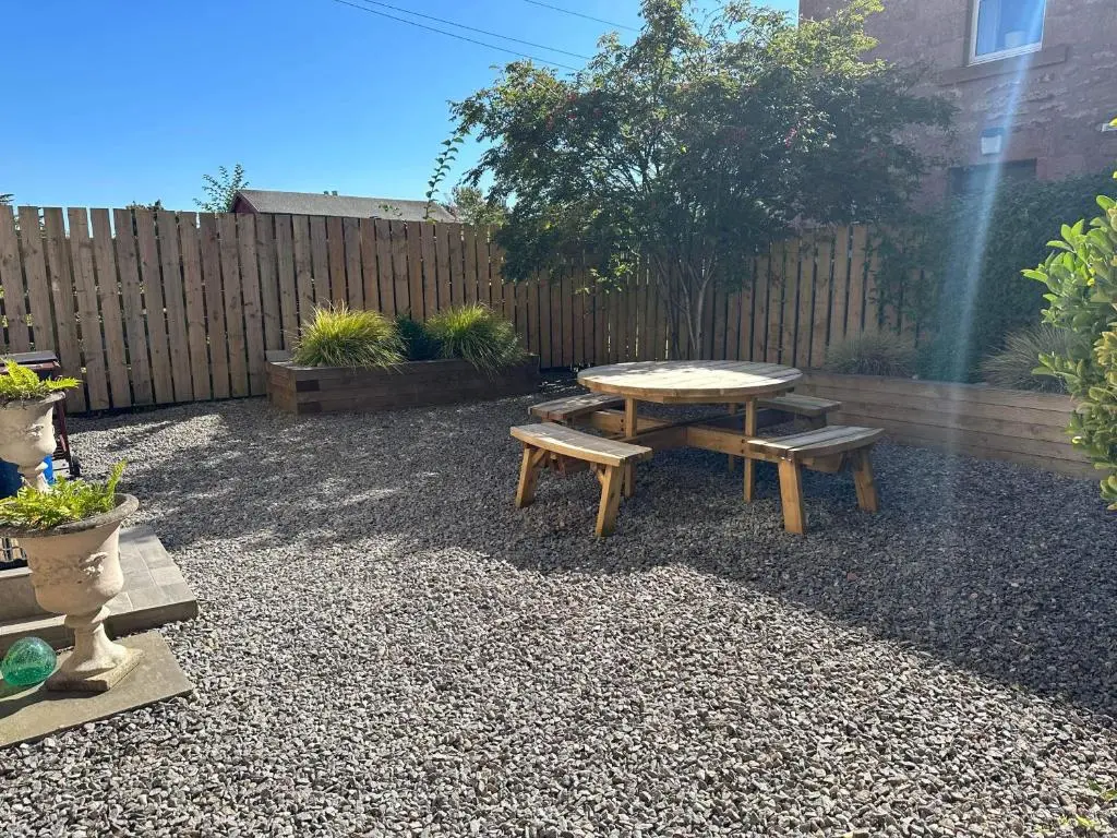a patio with a table and benches and a fence at Period House / Entire Upstairs Flat in Inverness