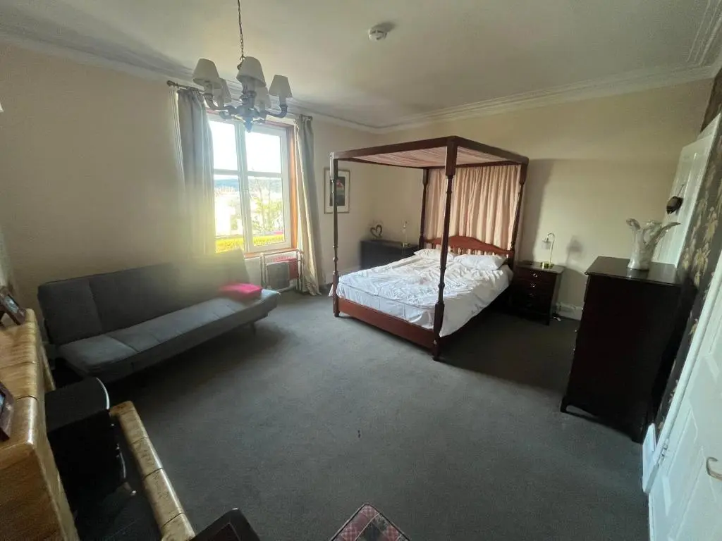 a living room with a bed and a couch at Period House / Entire Upstairs Flat in Inverness