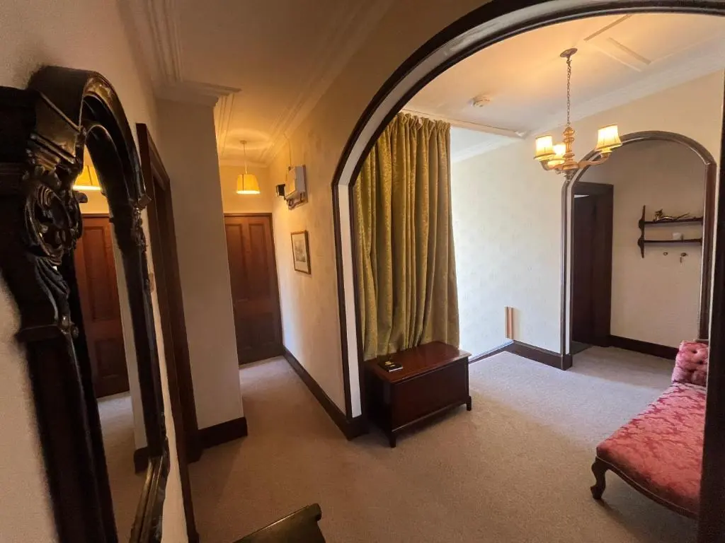 a hotel room with a mirror and a bed at Period House / Entire Upstairs Flat in Inverness
