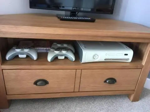 a entertainment center with two video game consoles and a tv at Number 5, Muirfield Court in Inverness