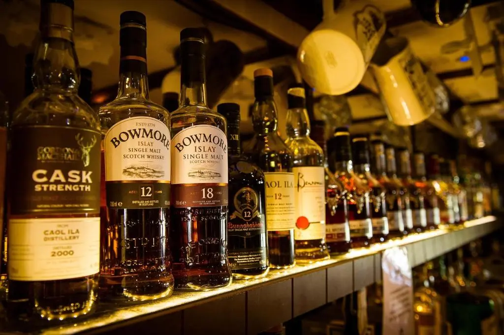 a shelf filled with lots of bottles of wine at The Bandstand in Nairn
