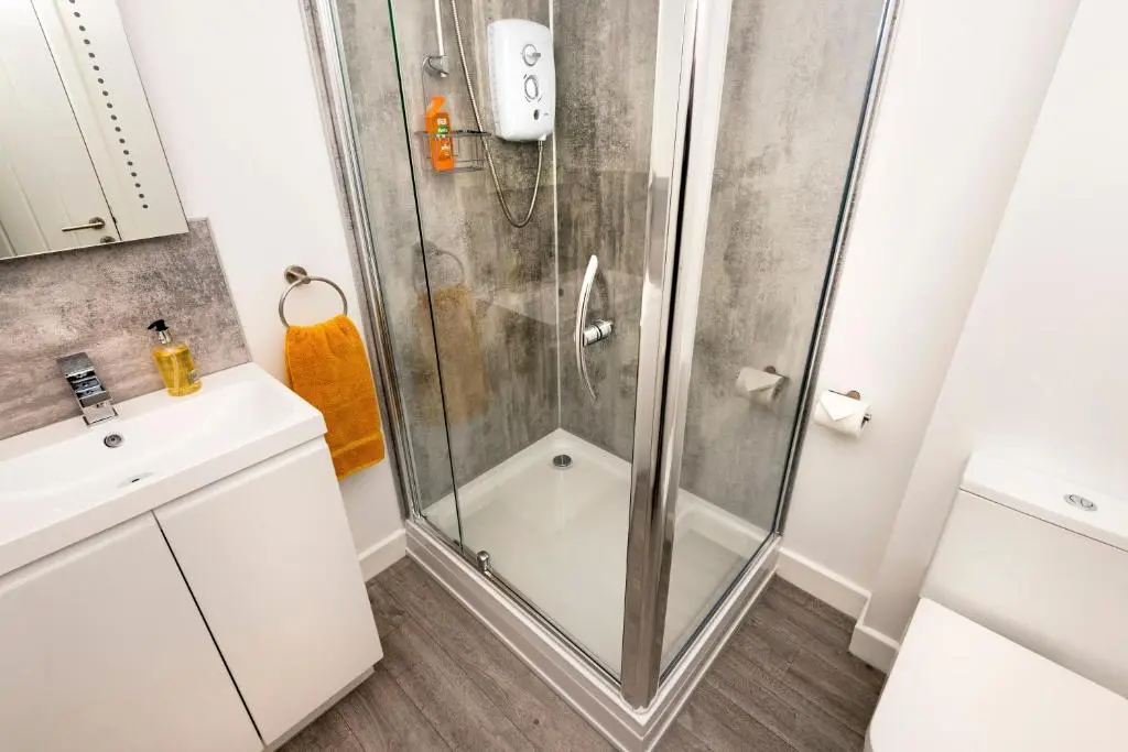 a bathroom with a shower and a sink at No. 6 Apartment in Inverness