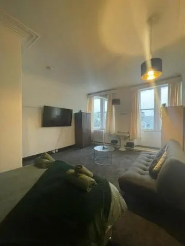 a living room with a bed and a couch at Carlton Hotel in Forres