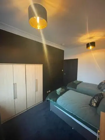 a bedroom with two beds and a light at Carlton Hotel in Forres