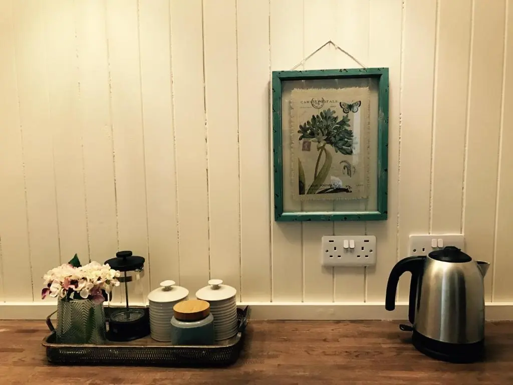 a tray with cups and plates and a kettle on a table at Dandaleith Cottage No.1 in Craigellachie