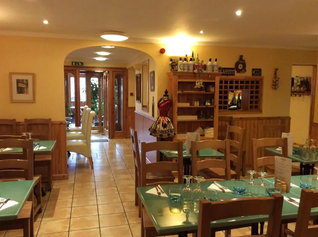 a restaurant with tables and chairs in a room at BORD DE L\u2019EAU APARTMENT in Wick