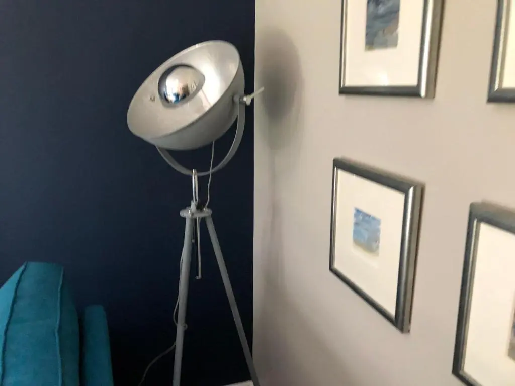 a room with a fan on a tripod next to a wall at Linmore in Aviemore