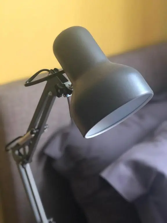 a black chair sitting on top of a bed at Linmore in Aviemore