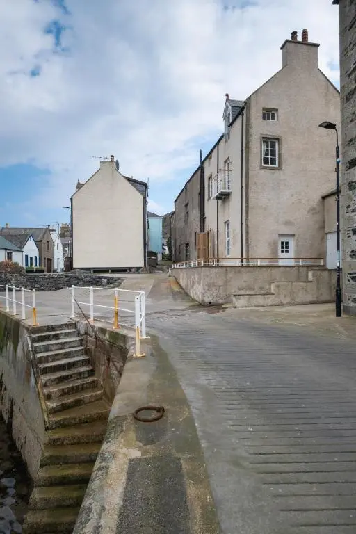 an empty street in front of a building at The Blue Hoose in Gardenstown